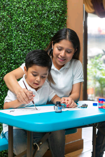 mom-helps-her-4-year-old-son-paint-with-a-brush.jpg