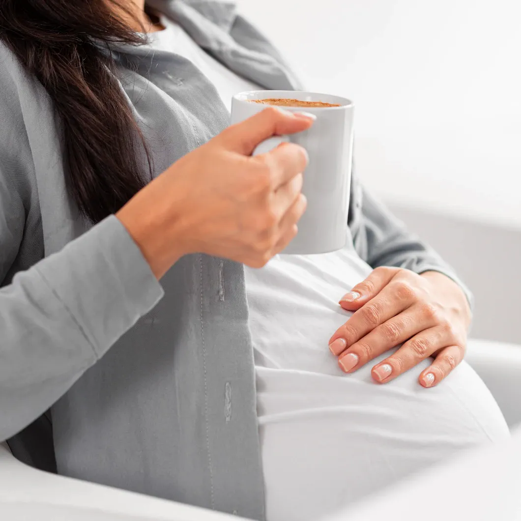 side-view-pregnant-woman-home-holding-mug-coffee_23-2148765086.webp