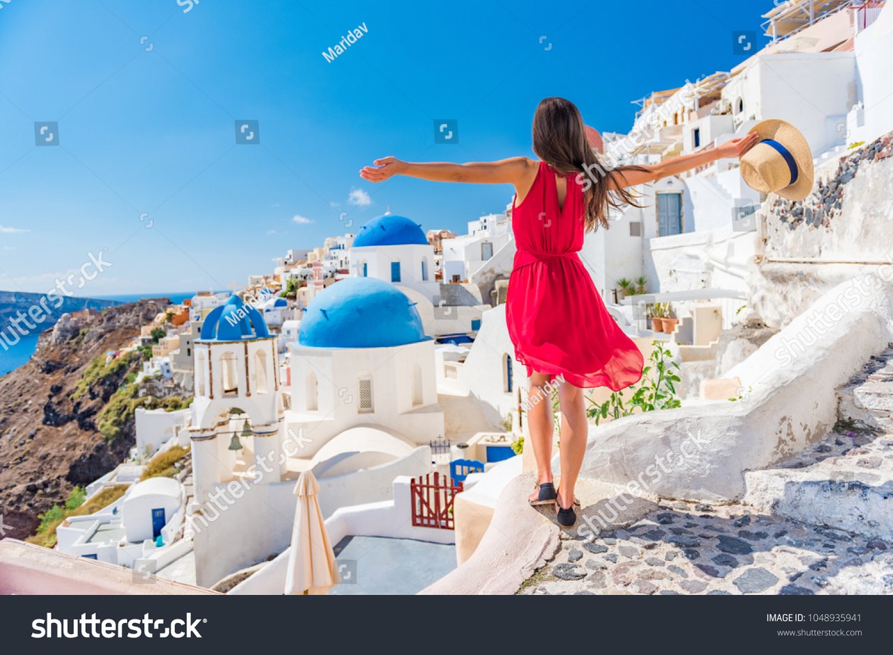 stock-photo-europe-travel-vacation-fun-summer-woman-dancing-in-freedom-with-arms-up-happy-in-oia-santorini-1048935941.jpg