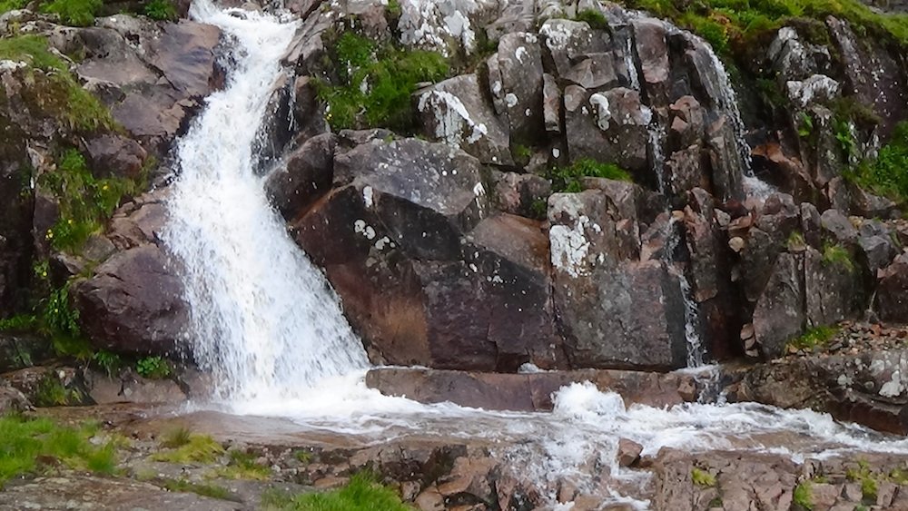 60 Amazing waterfall splashing onto flat pink rock.jpg