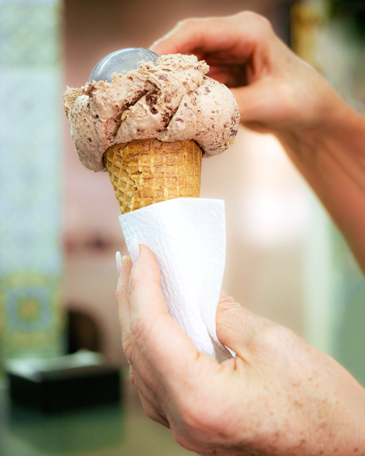 free-photo-of-hands-putting-a-scoop-of-chocolate-ice-cream-on-a-wafer.jpg