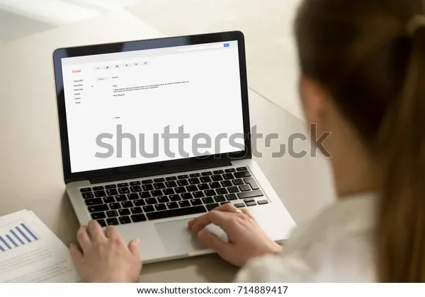 businesswoman-typing-email-on-laptop-600w-714889417.jpg