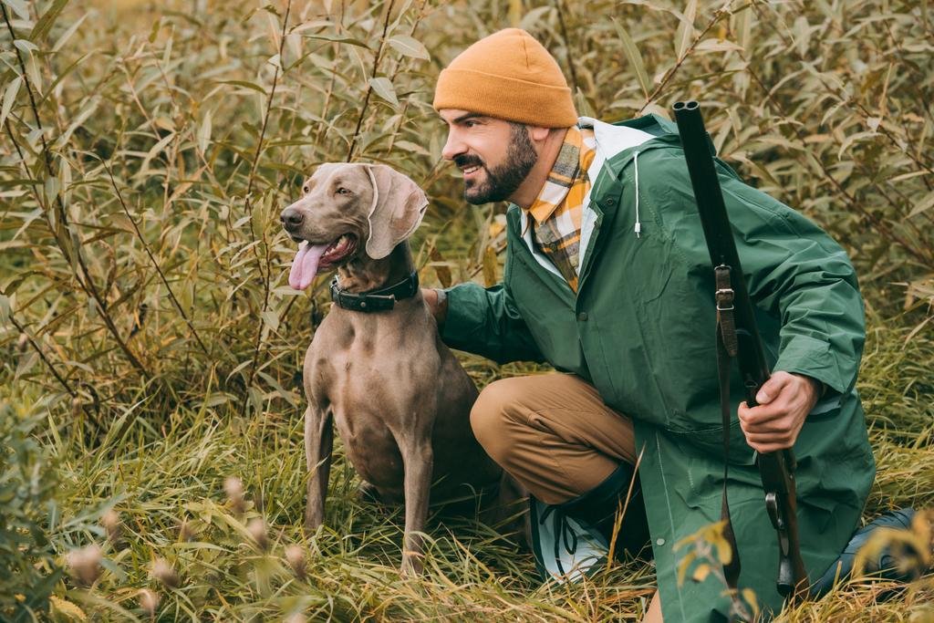 stock-photo-man-squatting-in-bushes-with.jpg