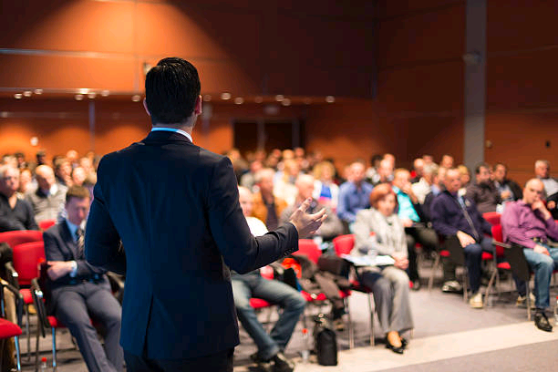 a-man-speaking-at-a-business-conference.jpg