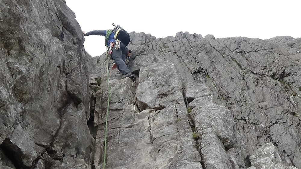 87 Kieran scaling the rocks with the rope.jpg