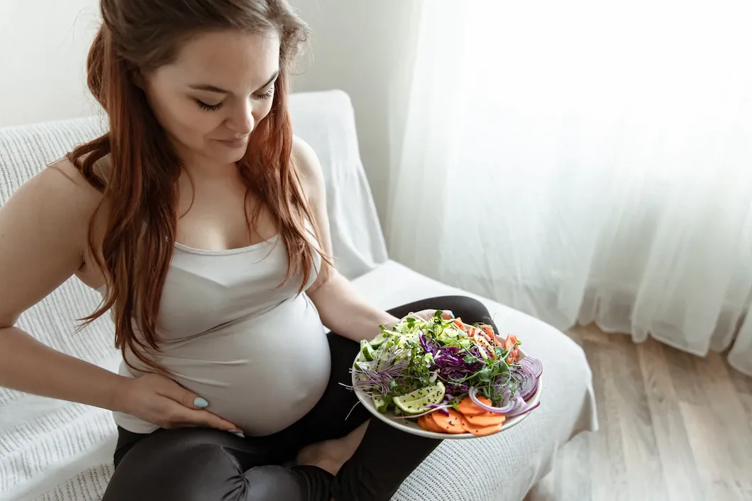 expectant-mother-last-months-pregnancy-is-holding-plate-vegetable-salad_169016-10999.webp