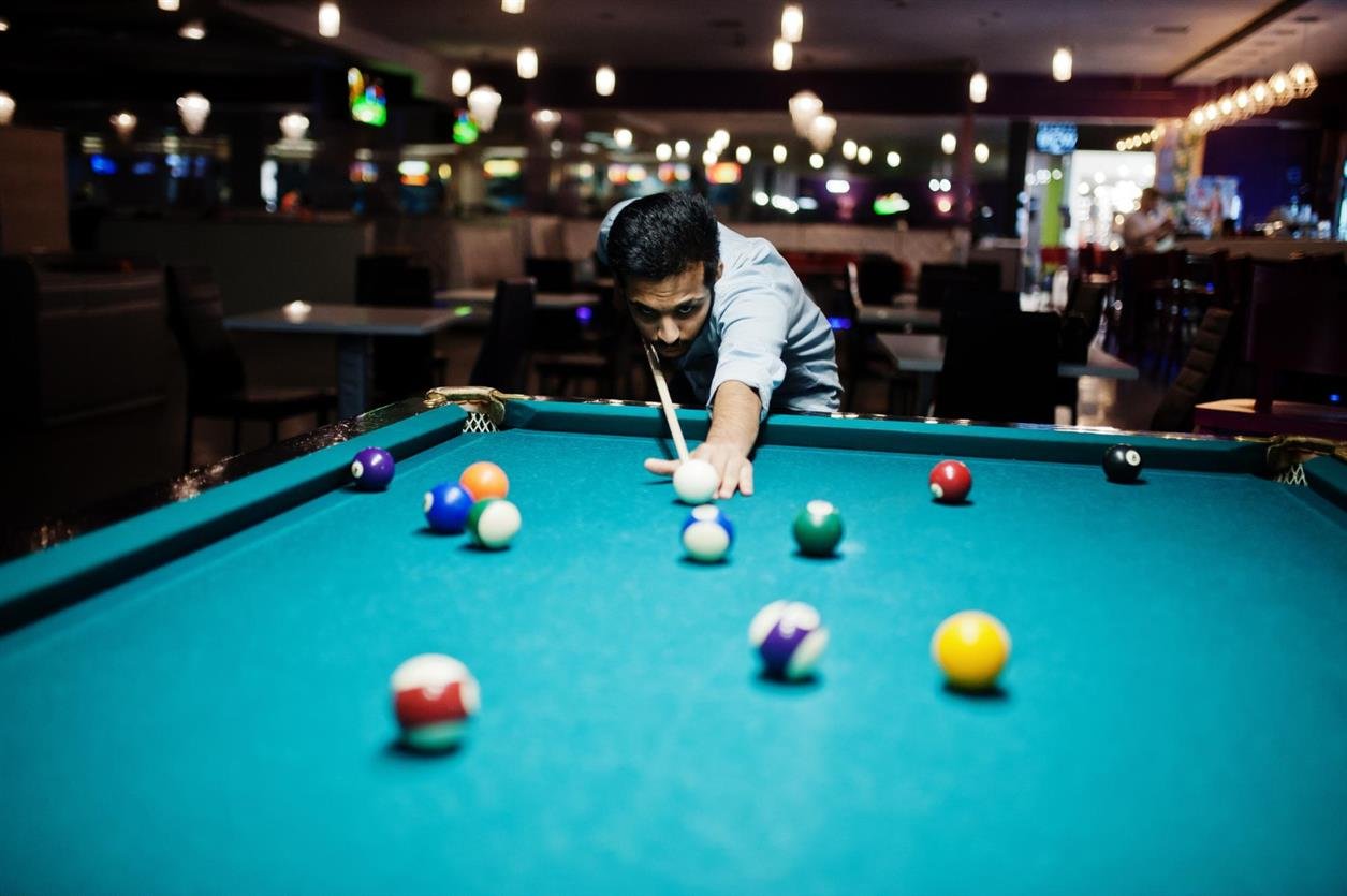 stylish-arabian-man-wear-jeans-playing-pool-billiard-bar.jpg