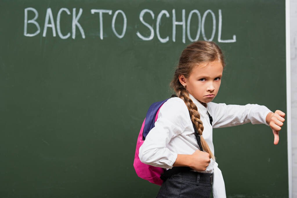 stock-photo-offended-schoolgirl-showing-thumb-looking.jpg