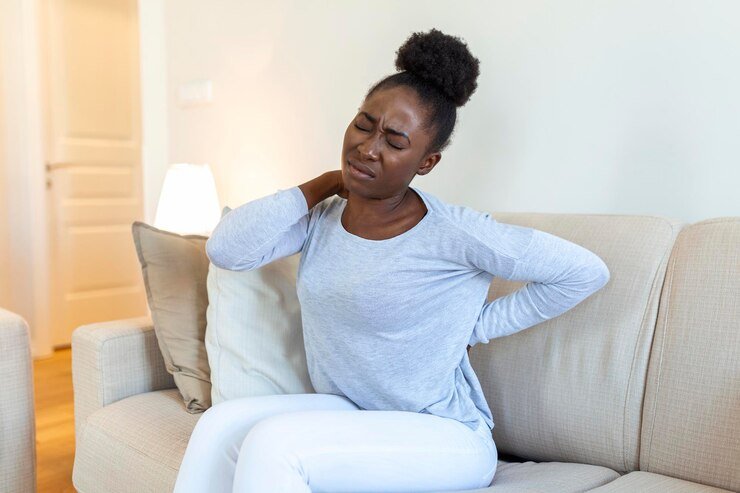 young-black-woman-suffering-from-backache-home-portrait-young-girl-sitting-couch-home-with-headache-back-pain-beautiful-woman-having-spinal-kidney-pain_657921-1629.jpg