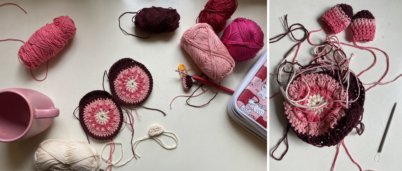 parts of a crochet amigurumi in pink hues, yarns and needles, hooks and a cup in pink