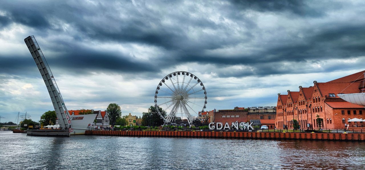 A ferris wheel on the right side of the old harbor.