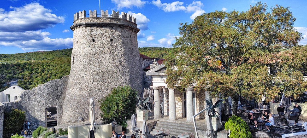 The tower is old, the theater looks like greek.