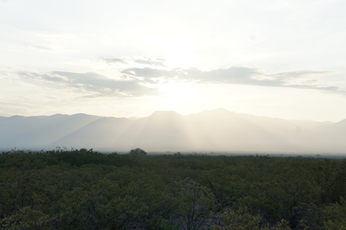 Sun over the mountains, spreading crepuscular rays