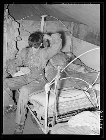 Son_of migrant_worker_putting_on_overalls Russell Lee, Harlingen, Texas, 1939 Farm security ad.jpg