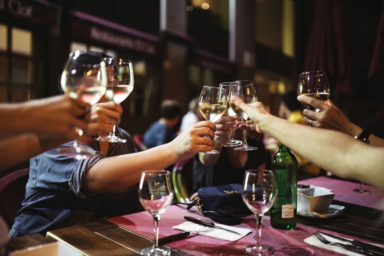 kaboompics_People holding glasses of white wine making a toast.jpg