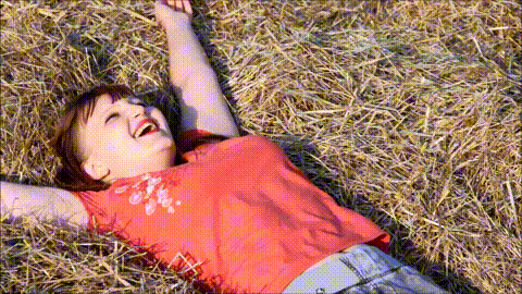 Young_woman_on_straw_enjoying_the_sun (1).gif