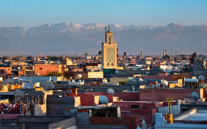 The Atlas Mountains rise behind the city of Marrakech