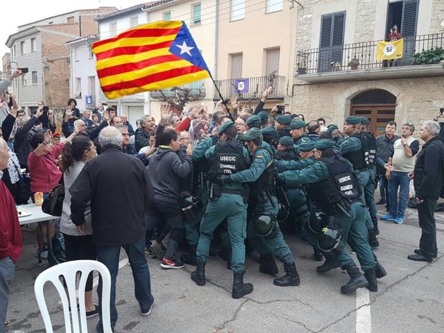 Spain's last effort to stop the vote comes in the form of members of Spain police try to hold the Catalonians back from the voting places!