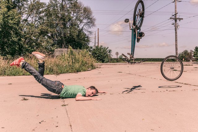 man falls bike broken