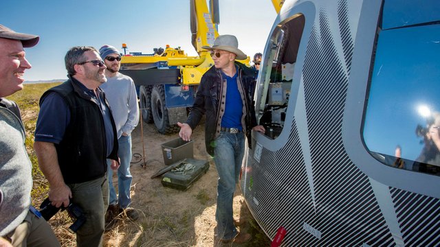 Image of Jeff Bezos with a Blue Origin space capsule