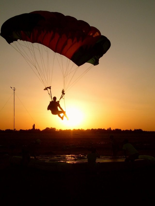 Man parachute in the sunset