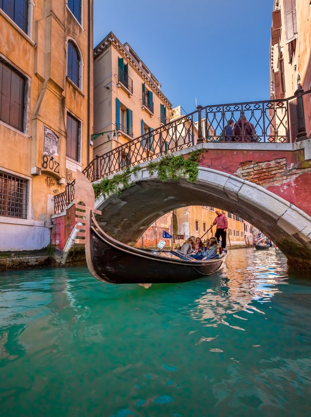 Traditional Venice Gondola Ride along Narrow Canal, Venice, Italy