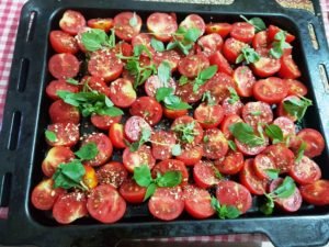 Arrange tomatoes skin side down in the baking tray