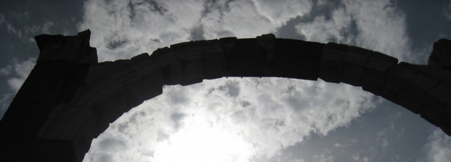 Gate archway against a cloudy sky