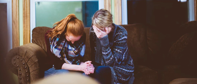 Two women talking and praying