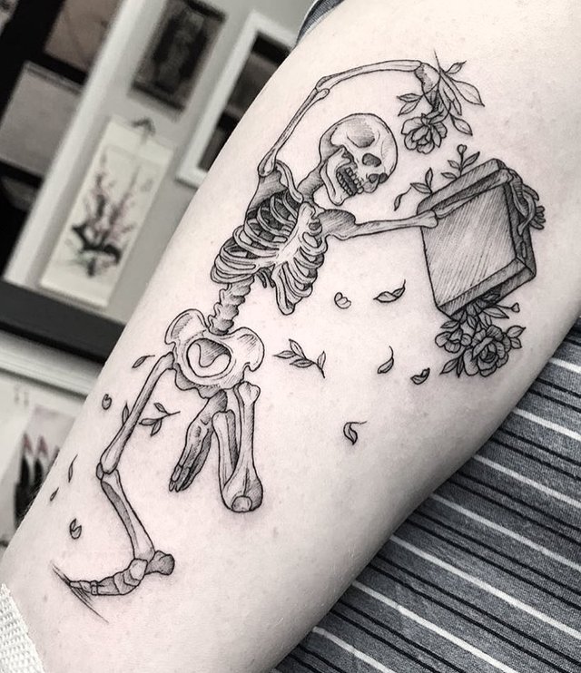 Fine line dancing skeleton tattoo on the inner arm