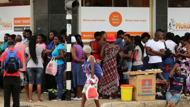 People queue outside of a bank in Harare. Withdrawals are often limited to $40 a day.