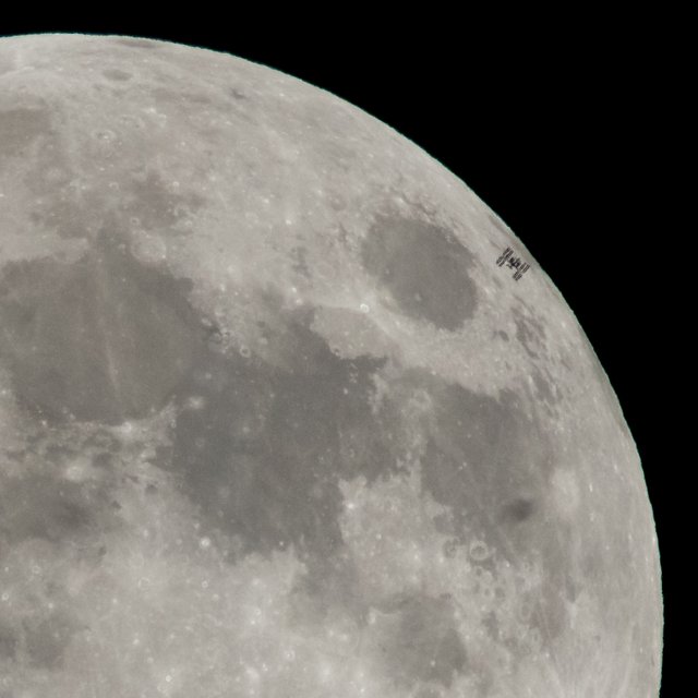 The International Space Station, with a crew of six onboard, is seen in silhouette as it transits the moon at roughly five miles per second on Tuesday, Jan. 30, 2018.