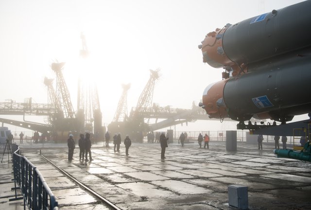 Workers are seen on the launch pad as the Soyuz rocket arrives after being rolled out by train, Monday, March 19, 2018 at the Baikonur Cosmodrome in Kazakhstan.