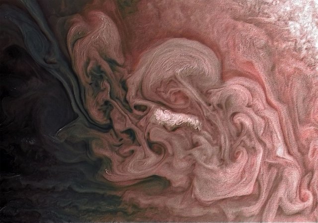 This image captures a close-up view of a storm with bright cloud tops in the northern hemisphere of Jupiter.