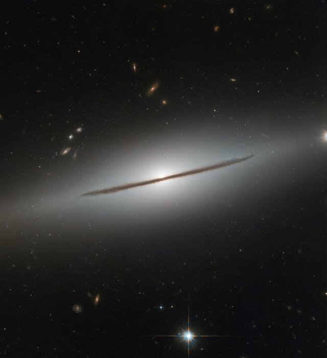 NGC 1032 cleaves the quiet darkness of space in two in this image from the NASA/ESA Hubble Space Telescope.