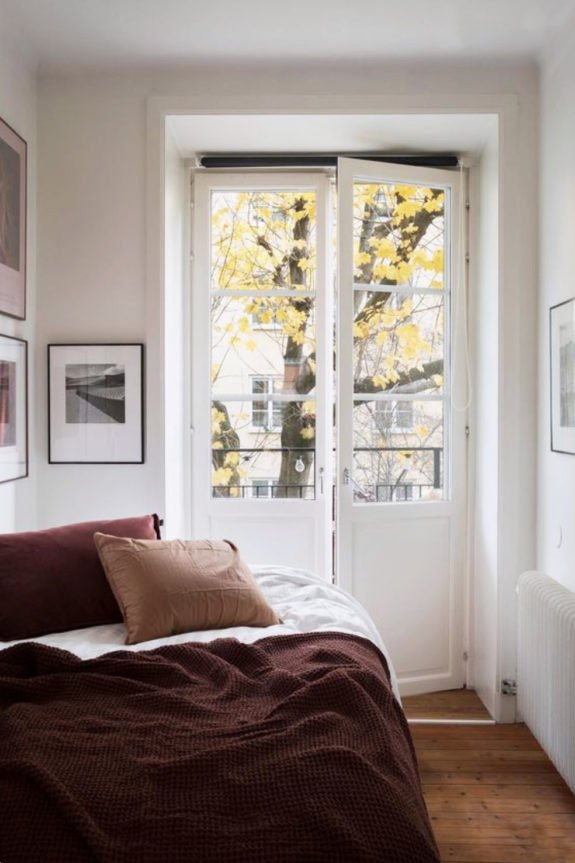 white walls and french doors in minimalist bedroom. / sfgirlbybay