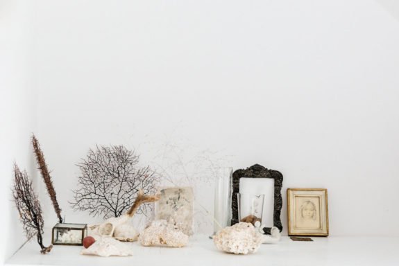 curated vignette with seashells and small framed prints. / sfgirlbybay