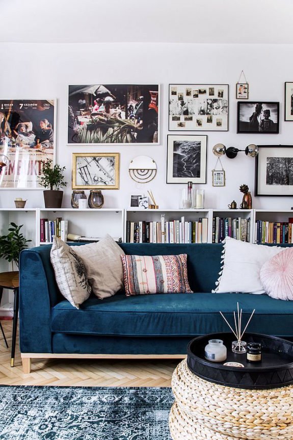 contemporary navy sofa with throw pillows in front of a chic art gallery wall. / sfgirlbybay