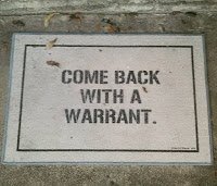 Welcome mat says "Come Back With a Warrant"
