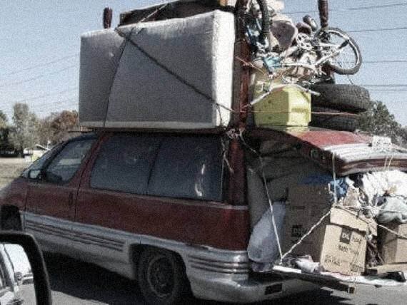 vanholio van overloaded with stuff on top, sagging down the back shocks
