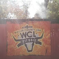 Smokestack above sign for Waller County Line Pit BBQ