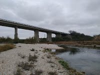 US 277 overpass of Sycamore Creek, creek below and dark clouds