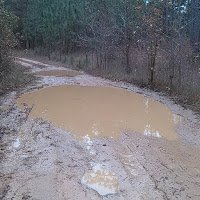 puddle in middle of dirt road