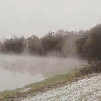 light snow in grass, mist rising above the pond in louisiana