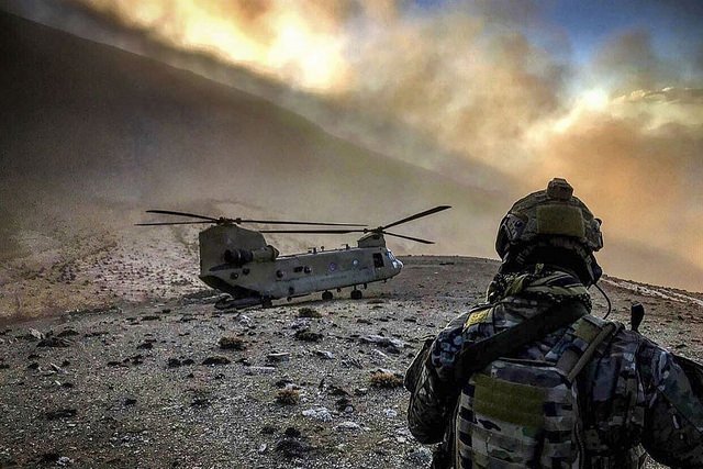 An airman observes a US Army An airman observes a US Army helicopter at an undisclosed location in Afghanistan, February 9, 2018. (Photo: The US Army)helicopter