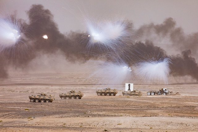 Omani tanks move towards a target, with smoke coming from missiles fired by UK and Omani forces during the Exercise Saif Sareea 3 Firepower demonstration.