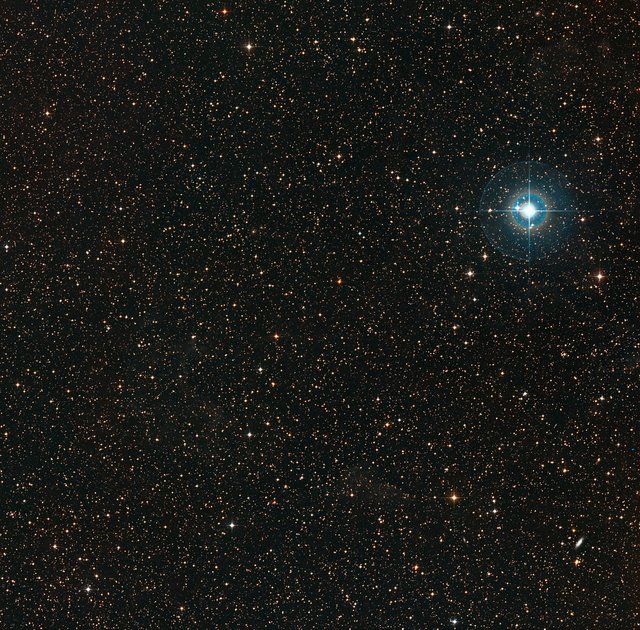 Surrounding environment of the PDS 70 visible in the centre. The bright Chi Centauri star on the right is approximately 510 light years from the Earth.