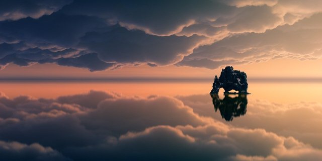 rocky isle between reflections of clouds in water and clouds