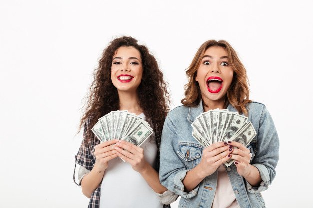 two-happy-girls-holding-money-rejoices-white-wall_171337-2664.jpg