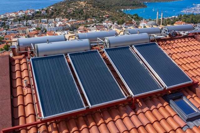 solar-water-heater-installed-tile-roof-house-eco-heating-water-large-water-tanks-horizontal-photo (1).jpg